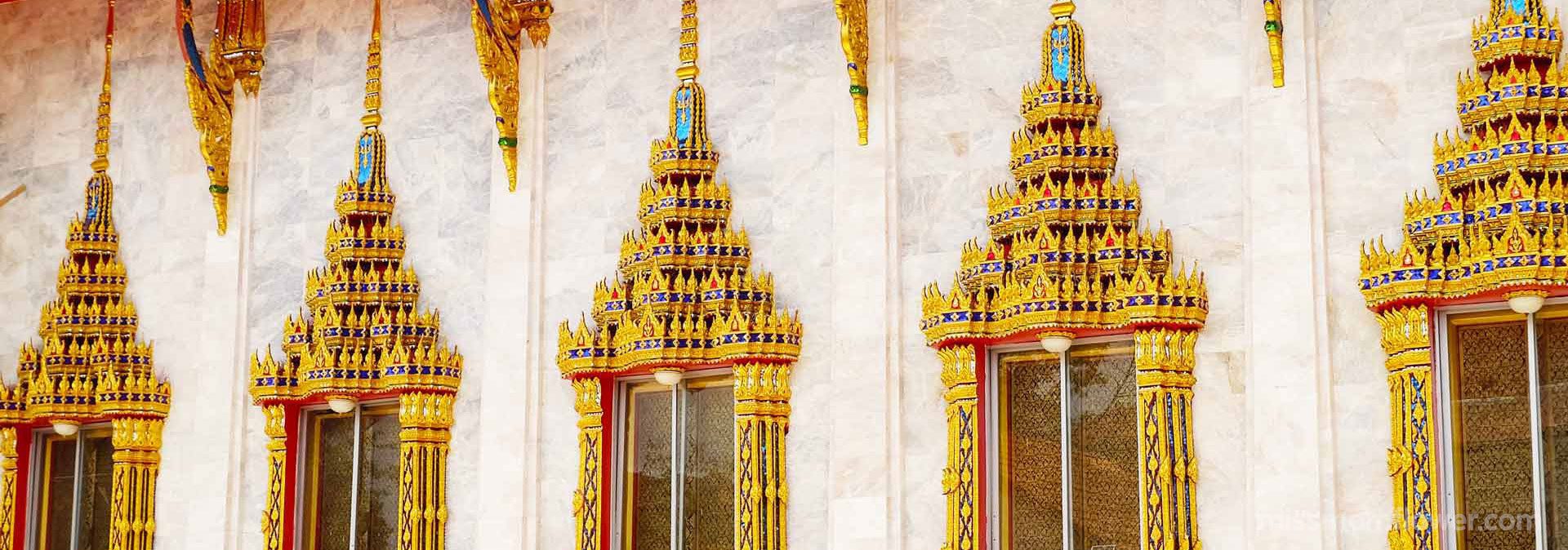 สถาปัตยกรรมแบบไทยสีทองที่บานหน้าต่างของอุโบสถวัดแก้วพิทักษ์เจริญธรรม